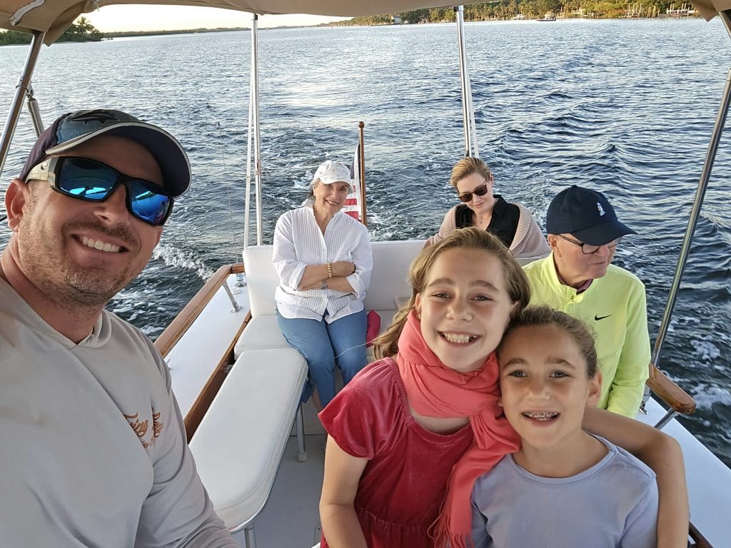 A group of people on a holiday boat tour taking a selfie.
